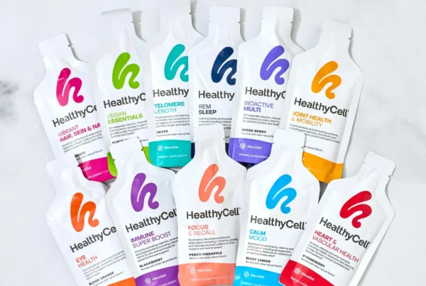 Assorted HealthyCell supplement packets arranged on a light surface