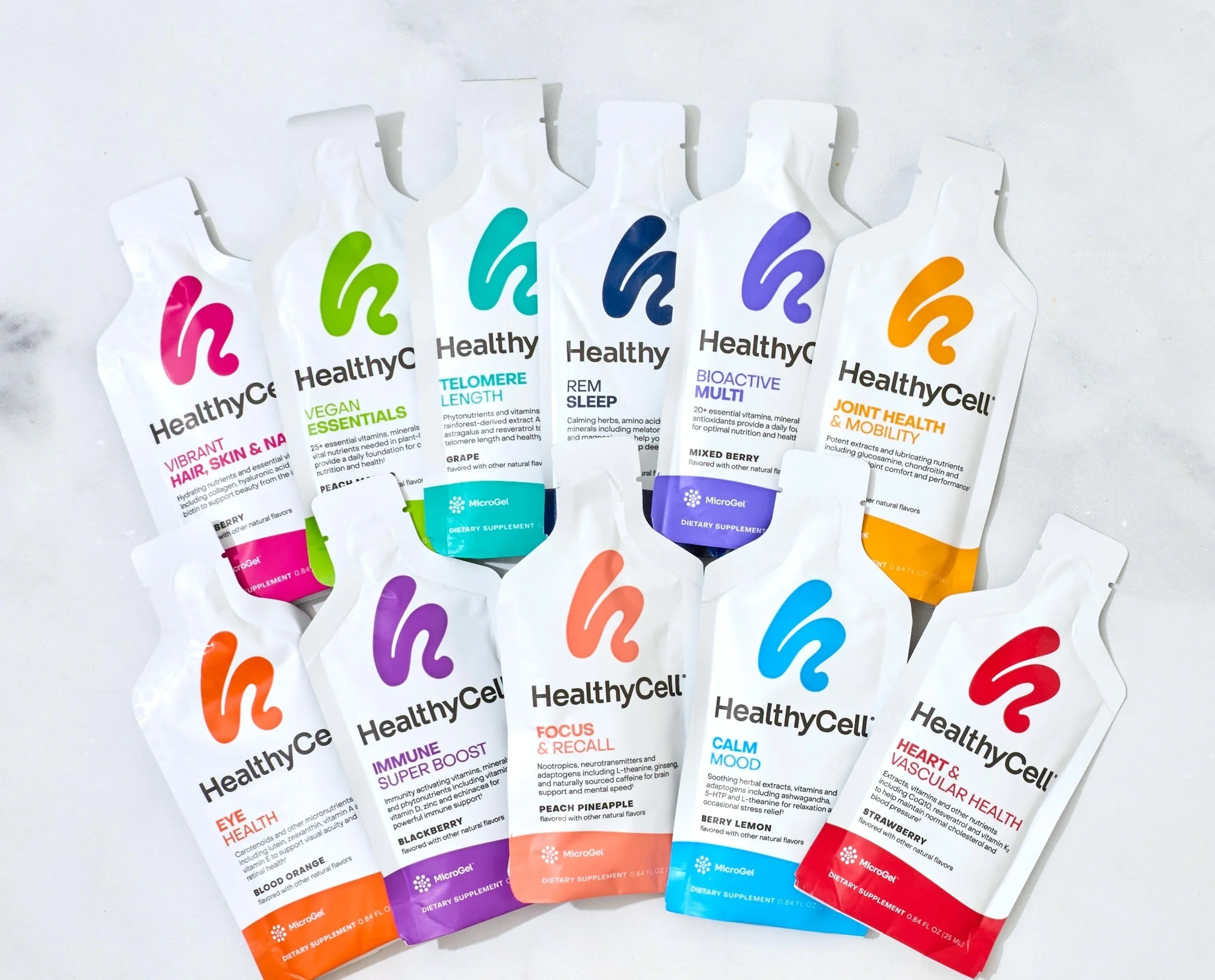 Assorted HealthyCell supplement packets arranged on a light surface